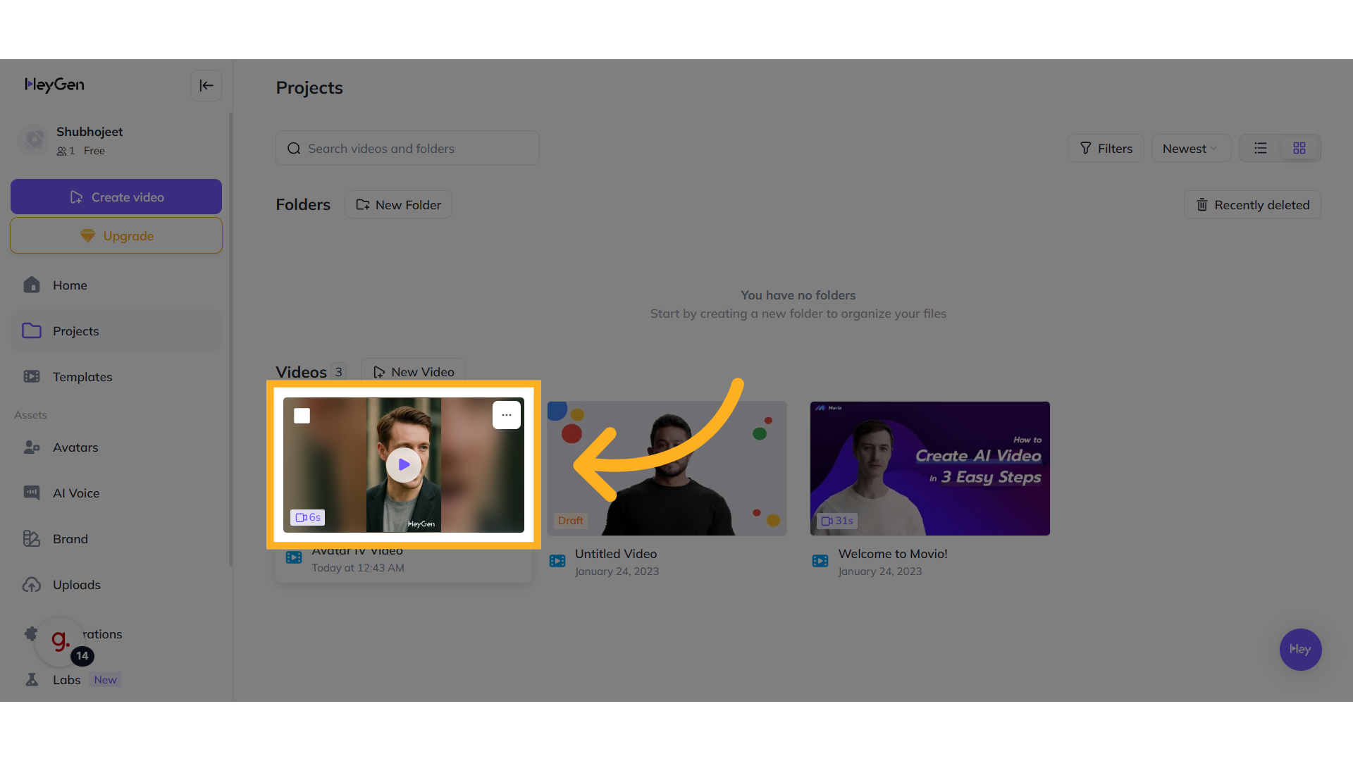 HeyGen project dashboard showing saved videos. A yellow arrow highlights a newly created Avatar IV video, among other video thumbnails like "Untitled Video" and “Welcome to Movio!”